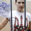 Ukrainian army pilot Nadezhda (Nadia) Savchenko holds a sign inside a defendants' cage as she attends a hearing at the Basmanny district court in Moscow February 10, 2015. A Moscow court extended on Tuesday the detention of Nadezhda Savchenko, a Ukrainian army pilot being held on charges of aiding the killing of two Russian journalists in east Ukraine last year. The sign reads, "I was born Ukrainian, and I die Ukrainian". REUTERS/Maxim Zmeyev (RUSSIA - Tags: CRIME LAW POLITICS CONFLICT)