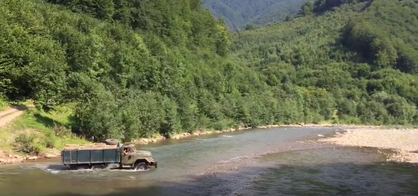 Навантажений лісовоз переїжджає гірську річку, відео