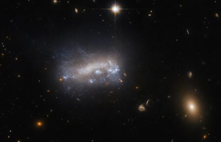 Телескоп «Хаббл» зазнімкував карликову галактику, яка проривається крізь щільний космічний газ